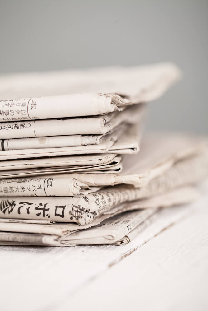 pile-newspapers-white-table (1)
